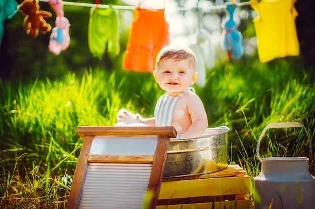 Little boy bathing in washbowl