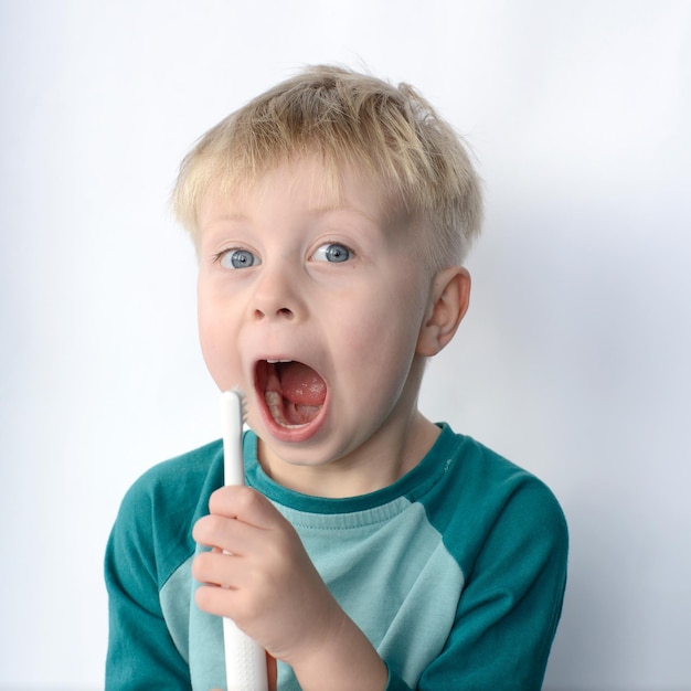 little boy brushing his teeth