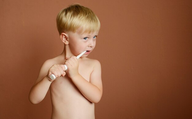 little boy brushing his teeth