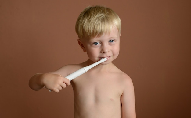 little boy brushing his teeth