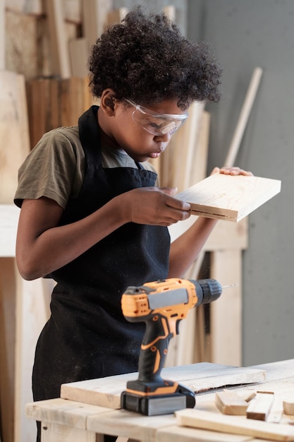 Little boy building in workshop