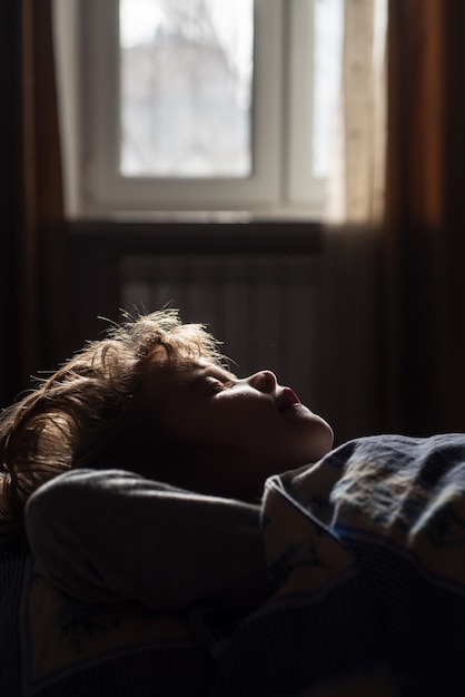 Little boy child sleeping in the bed. Kid sleep close up. Comfortable children sleepy at morning.