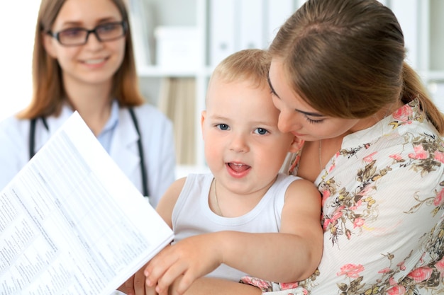 Little boy child with his mother after health exam at doctor's office