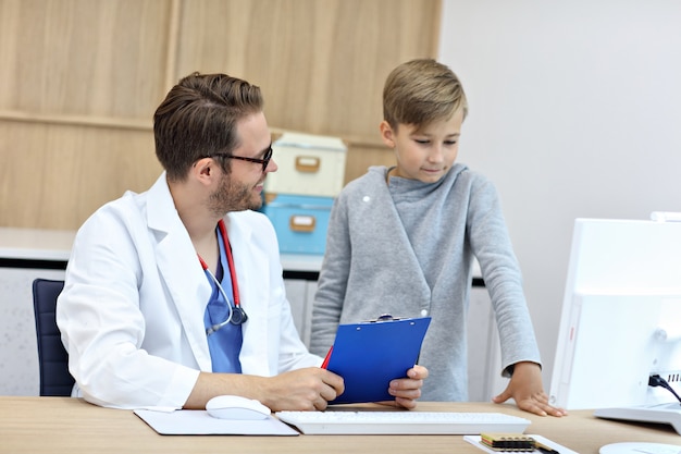 little boy in clinic being examined by pediatrician