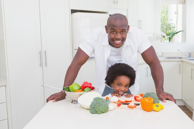 Little boy cooking with his father