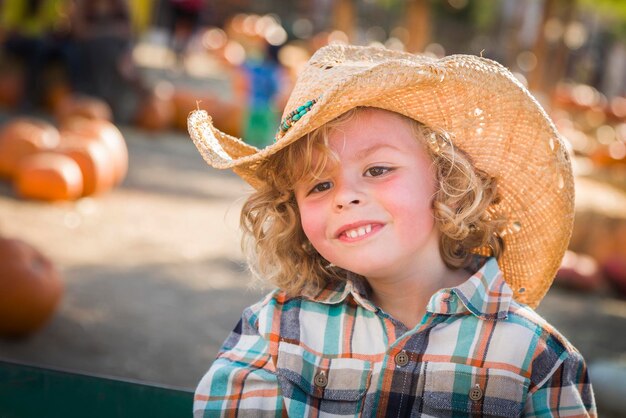 Little Boy in Cowboy Hat at Pumpkin Patch