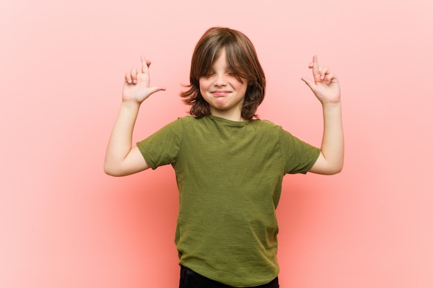 Little boy crossing fingers for having luck