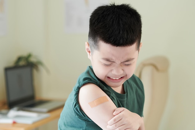 Little boy crying after vaccination