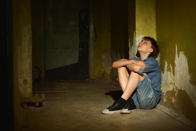 Little boy in dark cellar