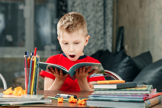 Little boy doing homework in school.