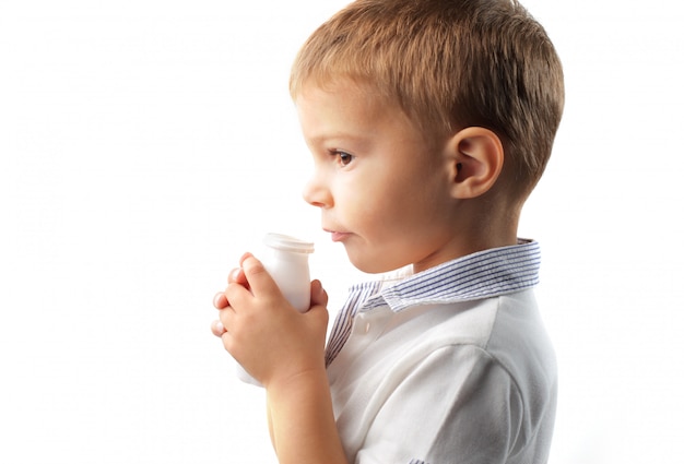 Little boy drinking yogurt