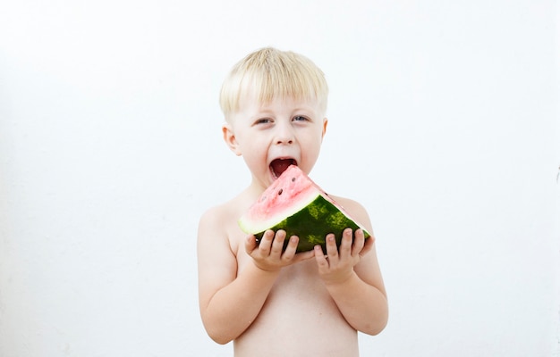 little boy eating watermelon