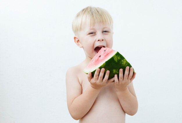 little boy eating watermelon