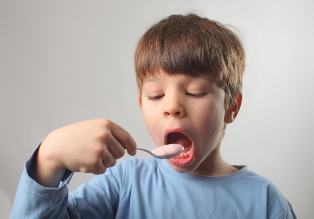 ヨーグルトを食べる少年