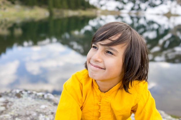 Little boy enjoying in vacation to mountain