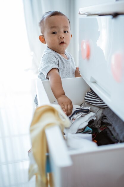 Little boy exploring his bedroom