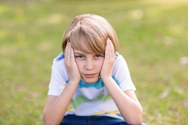 Little boy feeling sad in the park