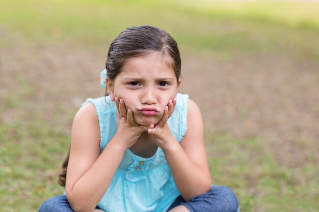 Little boy feeling sad in the park