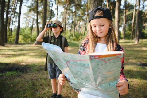 Little boy and girl go hiking on a forest road