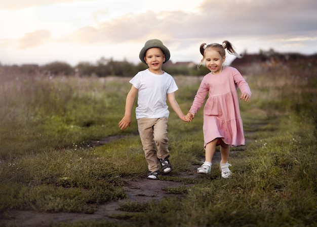 Little boy and girl running on the road