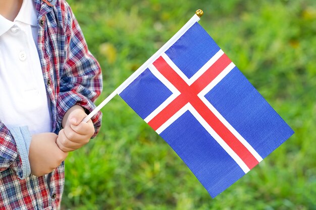 Little boy hands hold flag