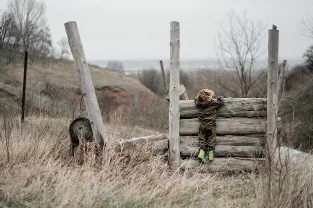 Little boy hanging on the fence