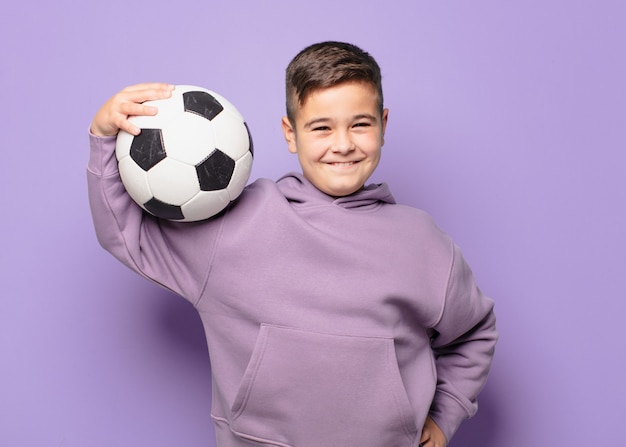 Little boy happy expression and holding a soccer ball