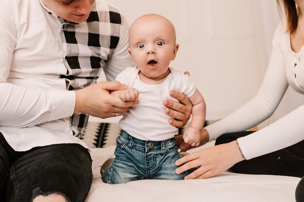 Little boy happy funny smiling laughing kid cute child baby playing with parents, crawling