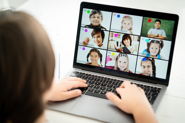 Little boy having online school distance learning class at home