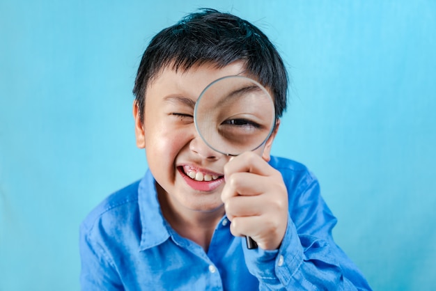 Little boy holding Magnifying glass