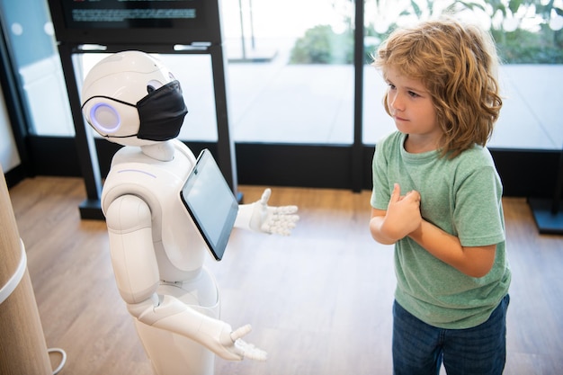 Little boy interact with robot artificial intelligence future tech