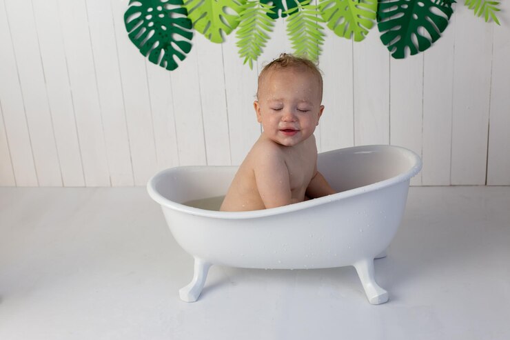 a little boy is bathing in the bath cute baby
