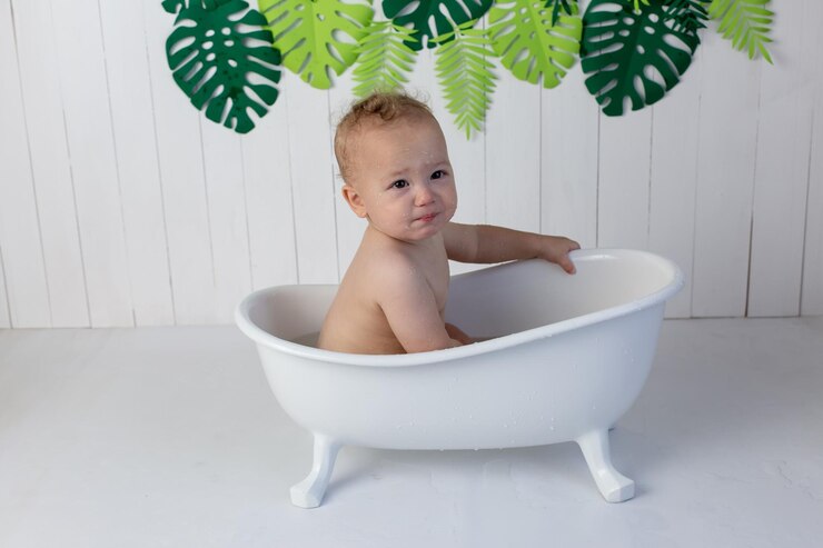 a little boy is bathing in the bath cute baby