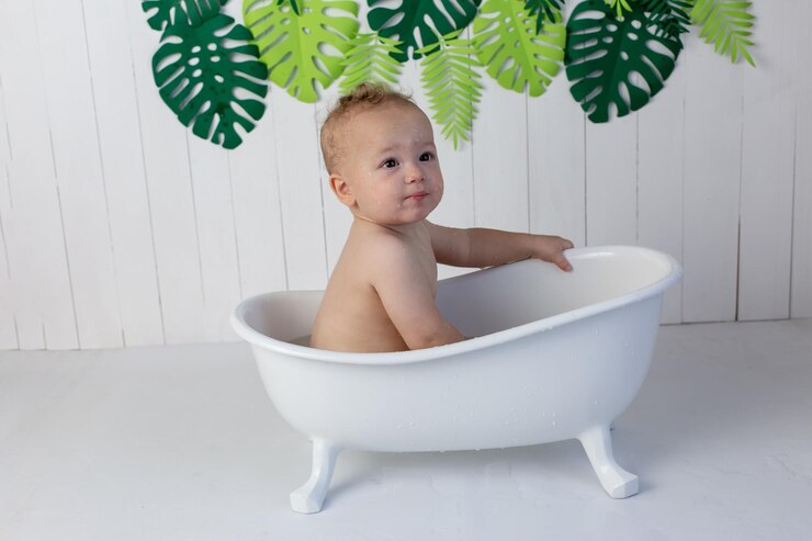a little boy is bathing in the bath cute baby