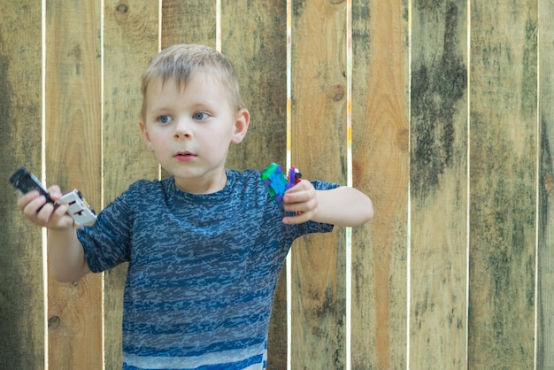 A little boy is holding toy cars