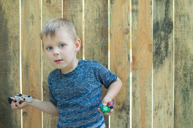 A little boy is holding toy cars