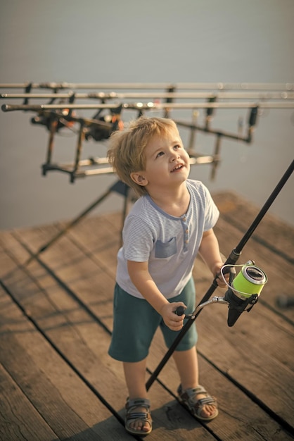 Little boy learn to catch fish in lake or river