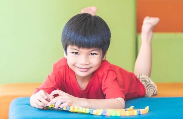 Little boy learning to play hard puzzle toy