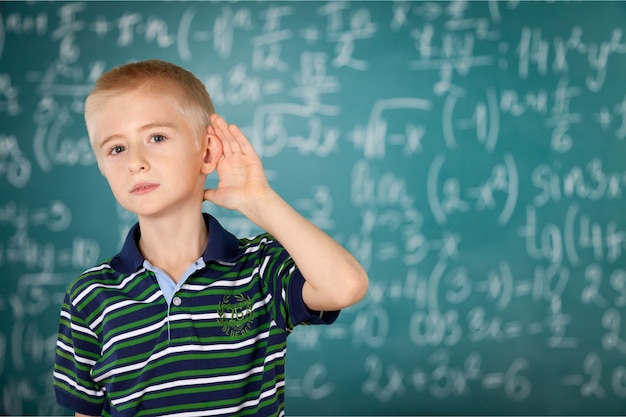 Little boy listening in the classroom