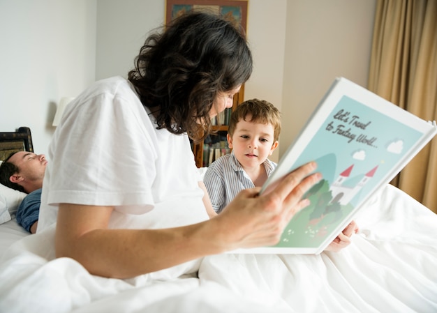 Studio di lettura della mamma di little boy prima di dormire