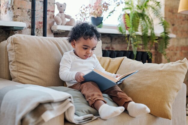 Little boy looking a book