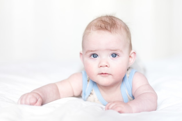 Little boy lying on a bed