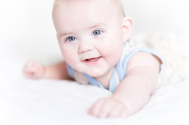 Little boy lying on a bed