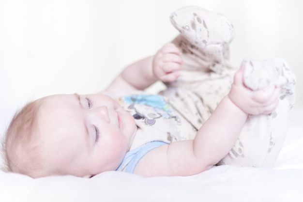 Little boy lying on a bed