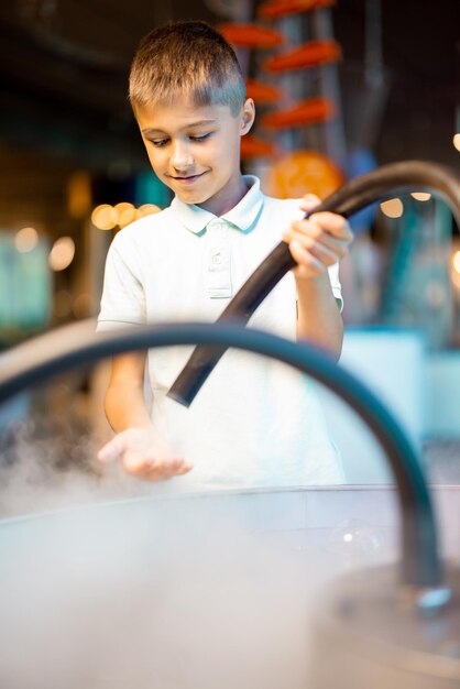 Little boy make soap bubbles in science museum