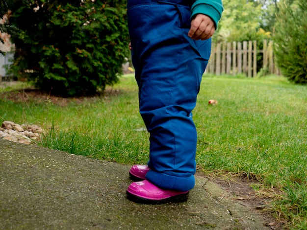 Little boy overalls play in the garden