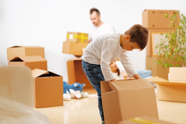 Little boy packing a moving box for a new home