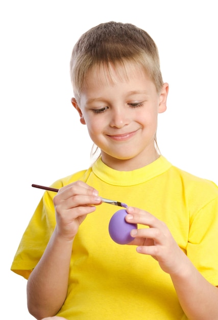 Little boy paints Easter eggs