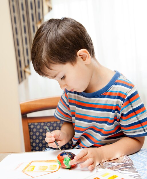 Little boy paints