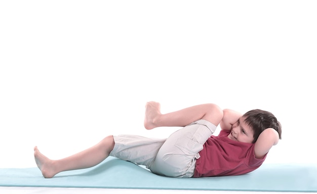 Little boy performs an exercise for the pressisolated on white